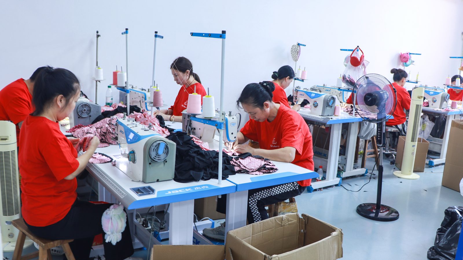 Sewing workshop — JACK industrial machines attaching woven cord to charm bracelets